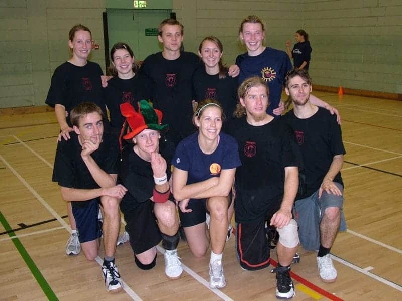 Active indoor sports team engaging in ultimate frisbee training or match.